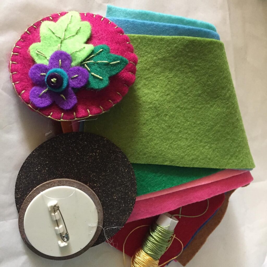 A felt sewing kit containing felt flowers, cotton, and felt fabric.